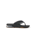 Fanning + men's black and gum flip flop facing left, close-up on the side showing cushioning and arch support.