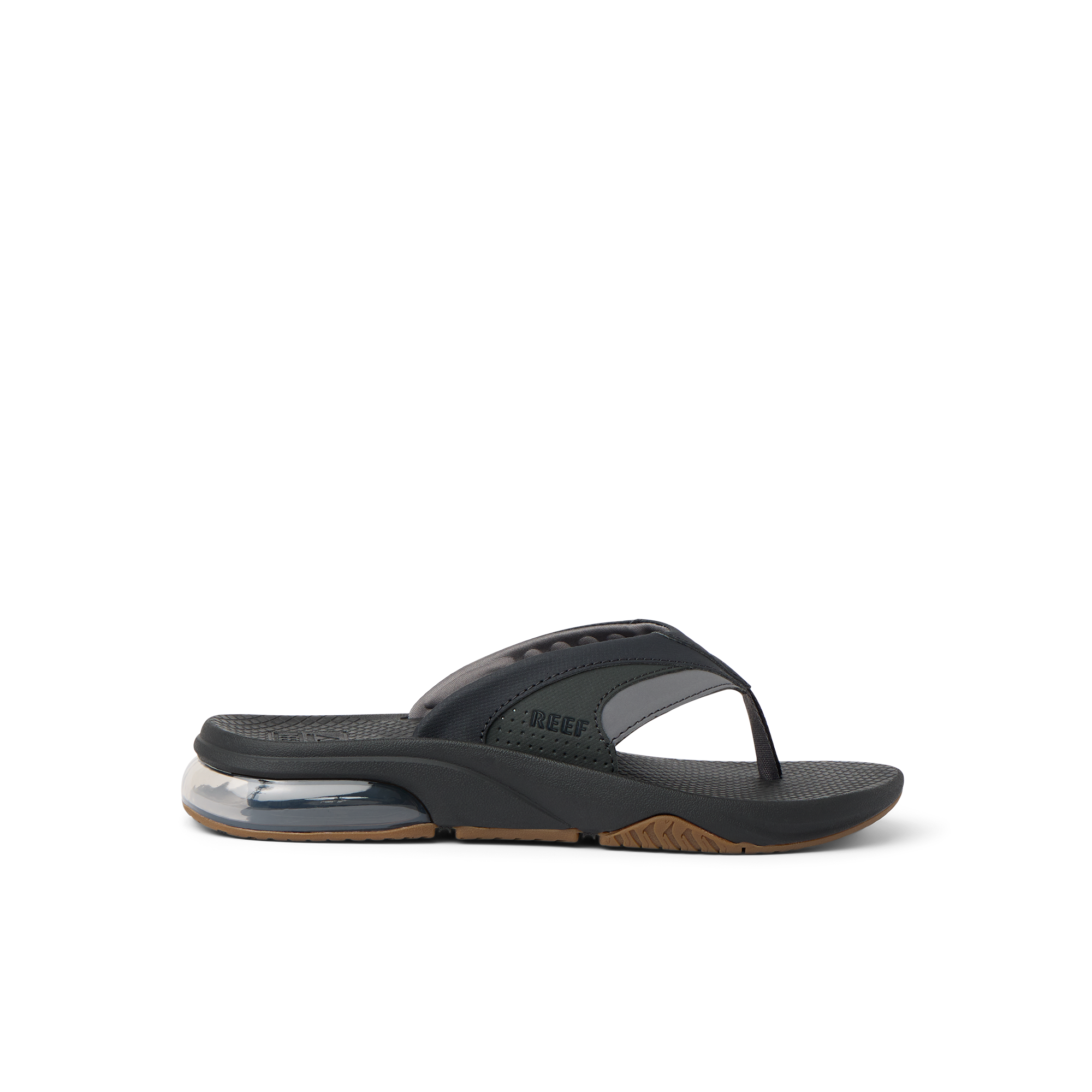 Fanning + men's black and gum flip flop facing left, close-up on the side showing cushioning and arch support.