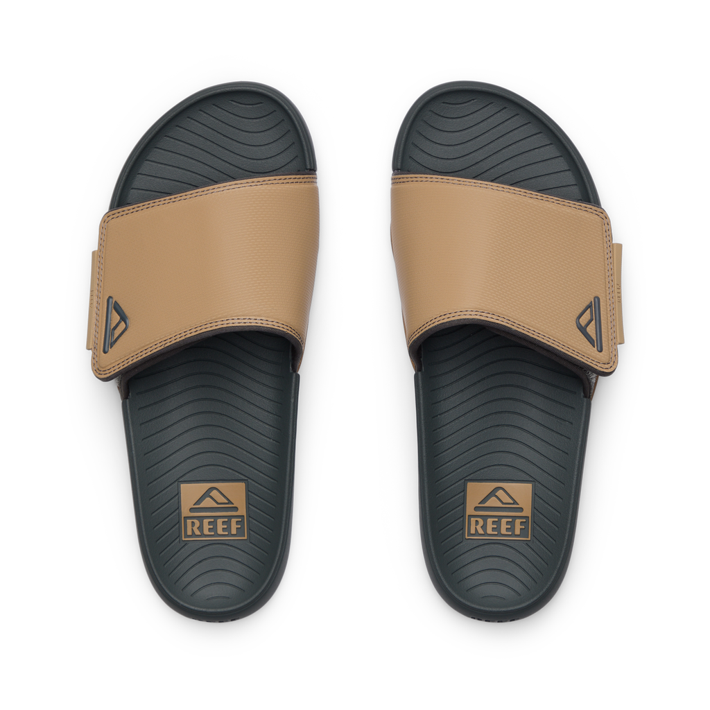 Phantom Slab men's slides facing up, tan straps with REEF logo, cushioned footbed with arch support for beach comfort.