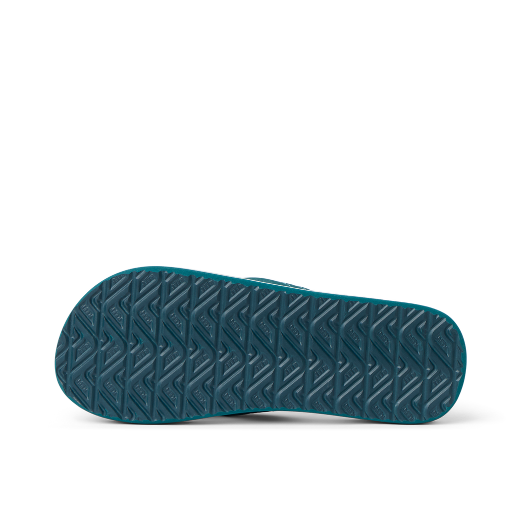 Kids Ahi shoe sole facing up showing durable, textured tread designed for comfort and beach use, kids boys footwear by REEF.