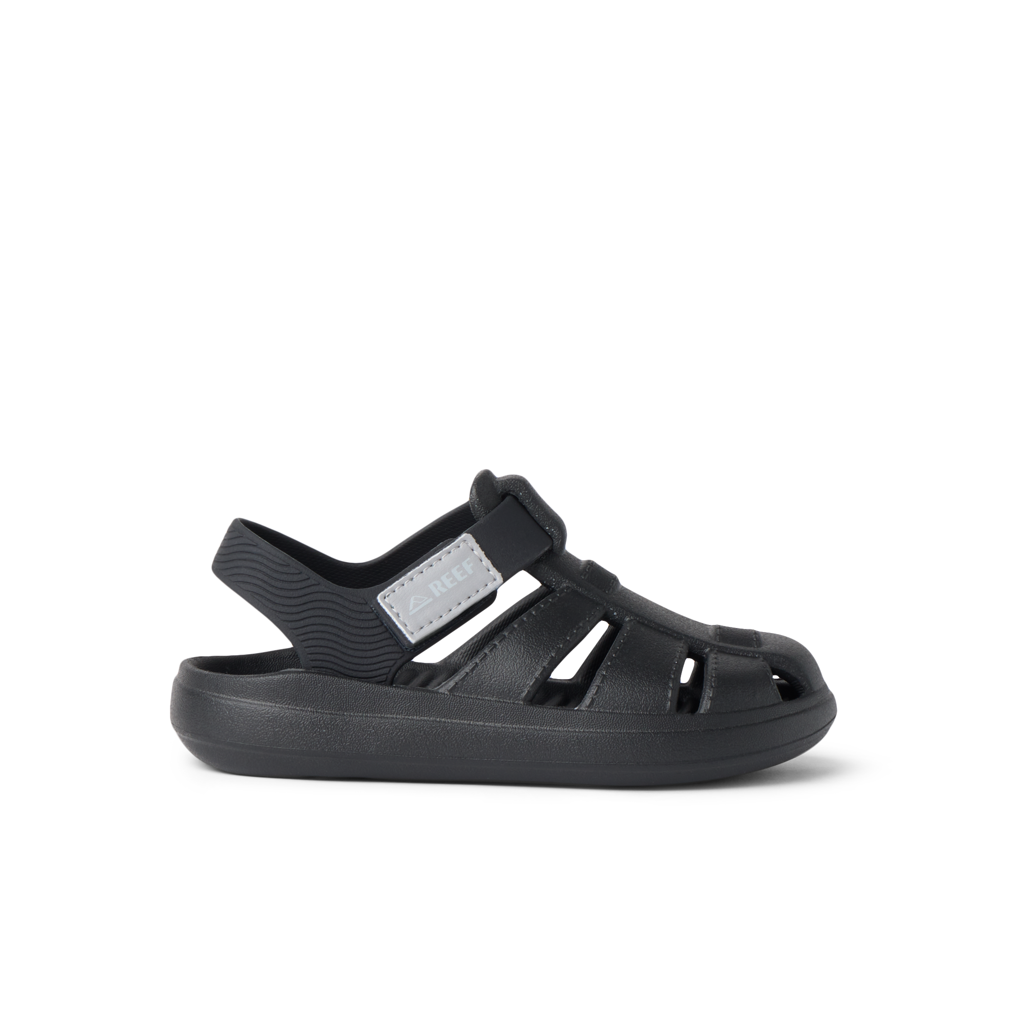 Little Totally Beachin black boys sandal facing left, close-up of lightweight, cushioned beach-inspired footwear.