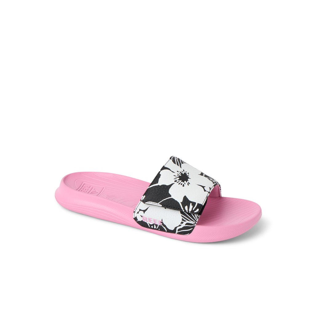 Kids Salty Slide left-facing with pink cushioned footbed and black-and-white floral strap, beach-inspired comfort design