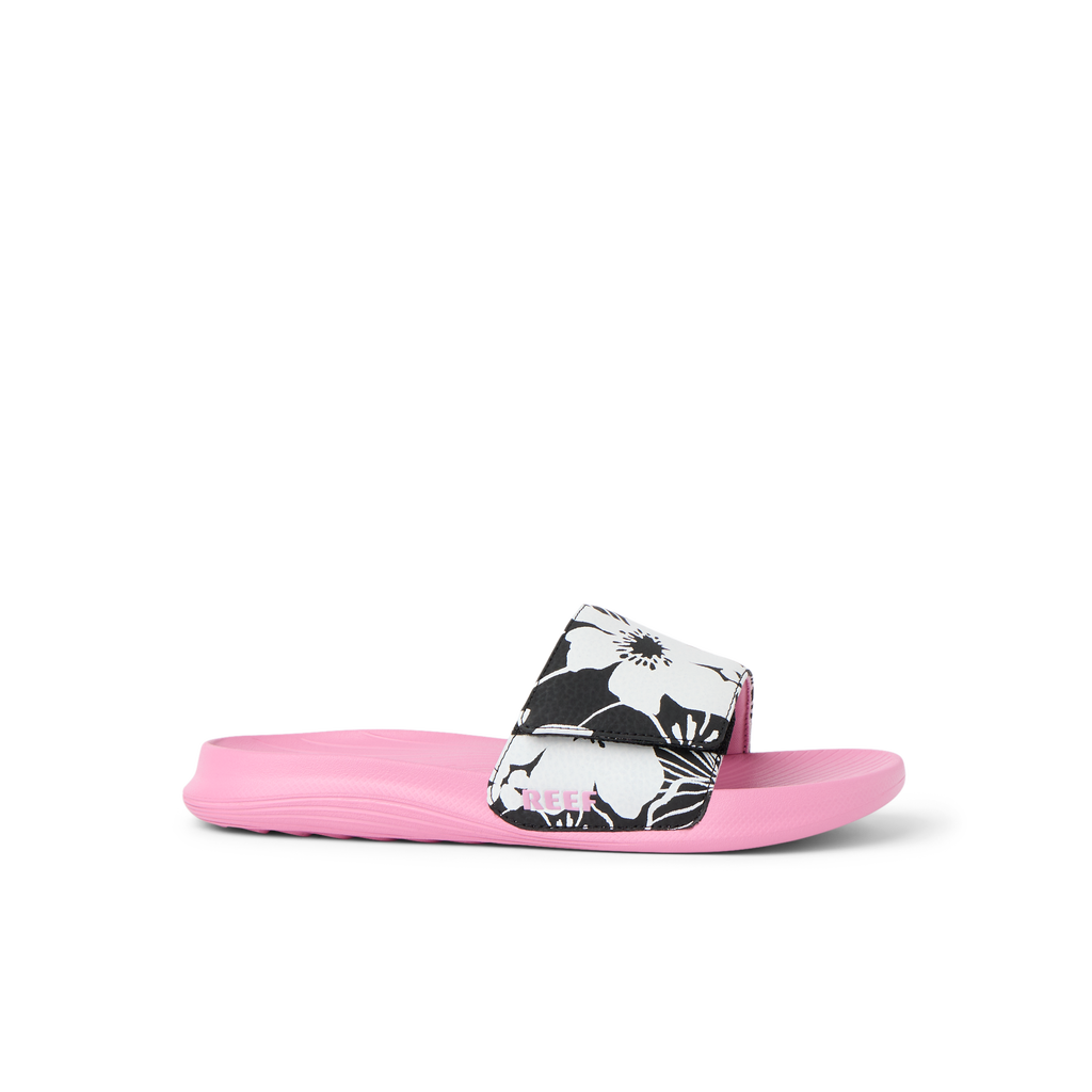 Kids Salty Slide girls’ left-facing pink slide sandal with black and white floral strap, cushioned and water-friendly comfort.