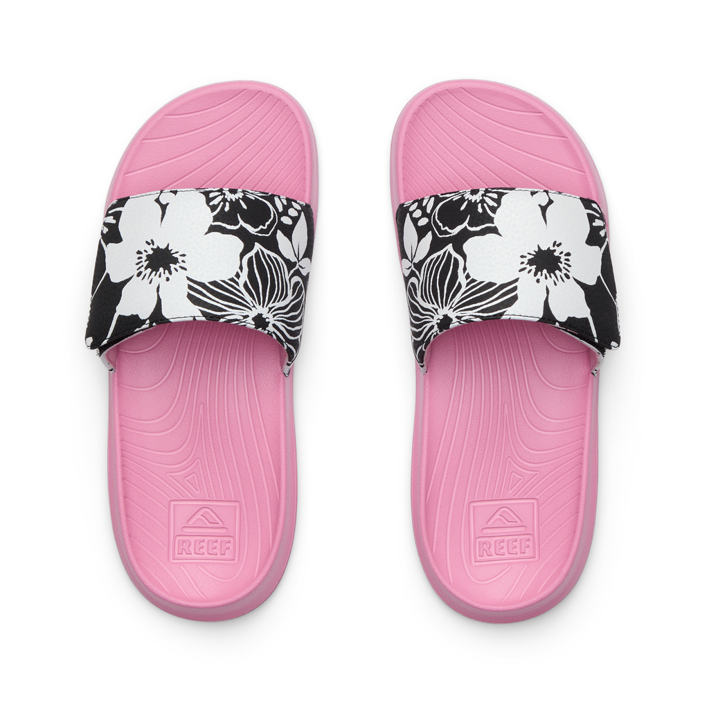 Kids Salty Slide top view facing up, pink footbed with black and white floral strap, water-friendly slides for girls aged 5-10.