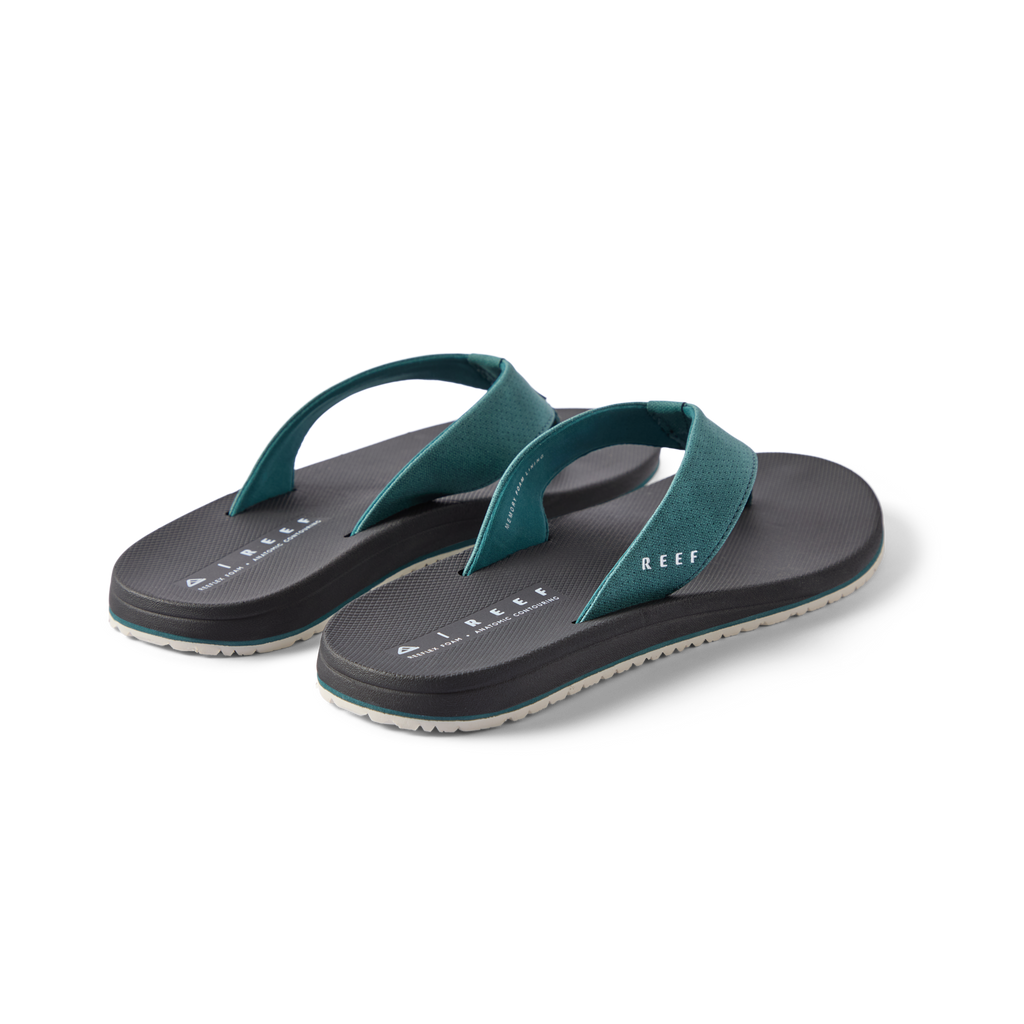 Pair of Nox men's teal and black flip flops facing right, featuring soft cushioning and anatomical arch support.