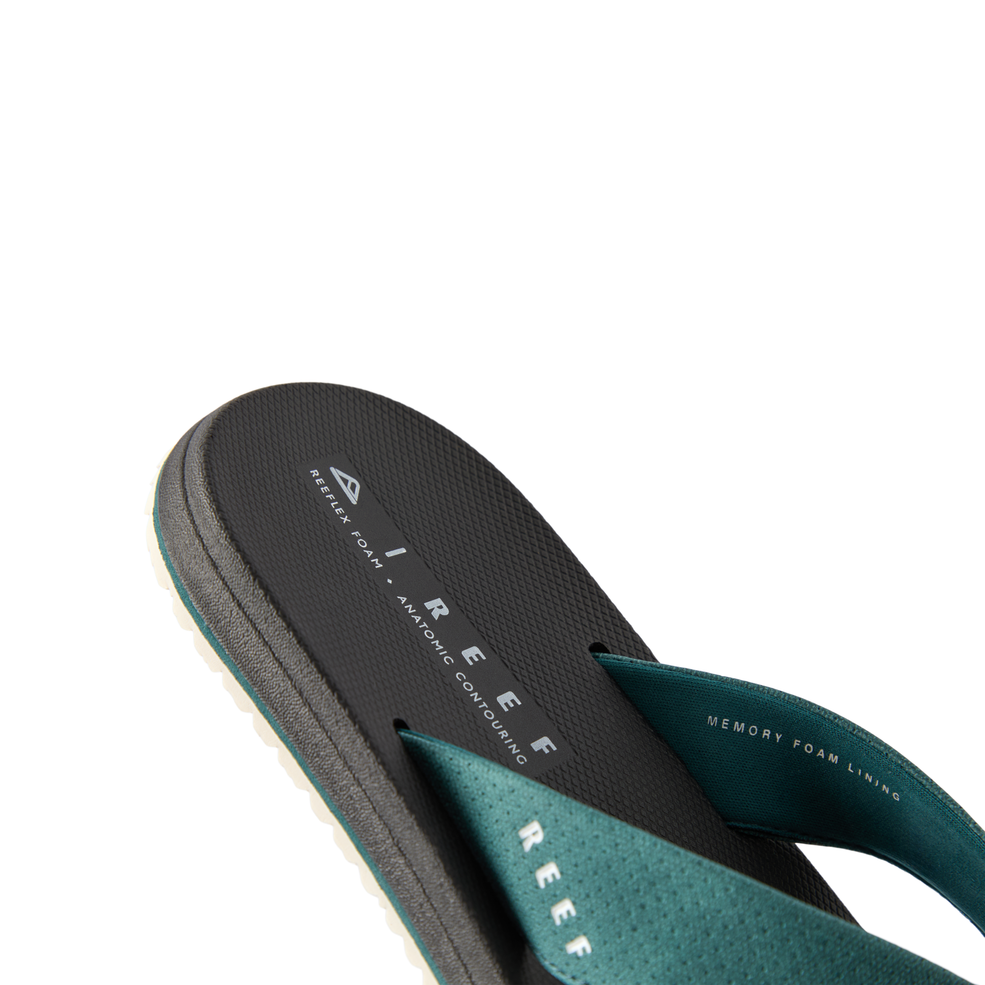Nox men’s sandal facing left, close-up of the footbed and teal strap with memory foam for beach comfort.