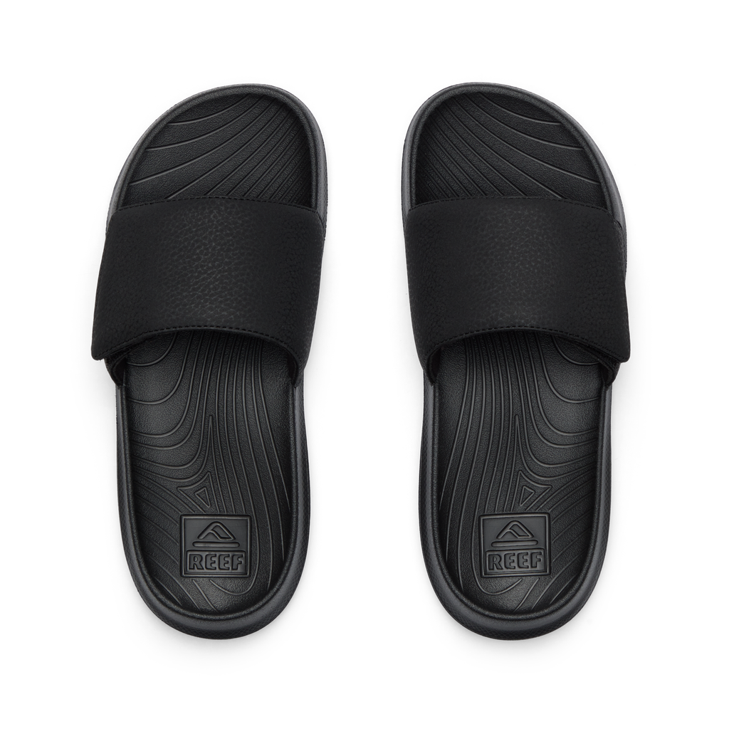 Kids Salty Slide top view showing black water-friendly slides with anatomical arch support and soft cushioning for boys.