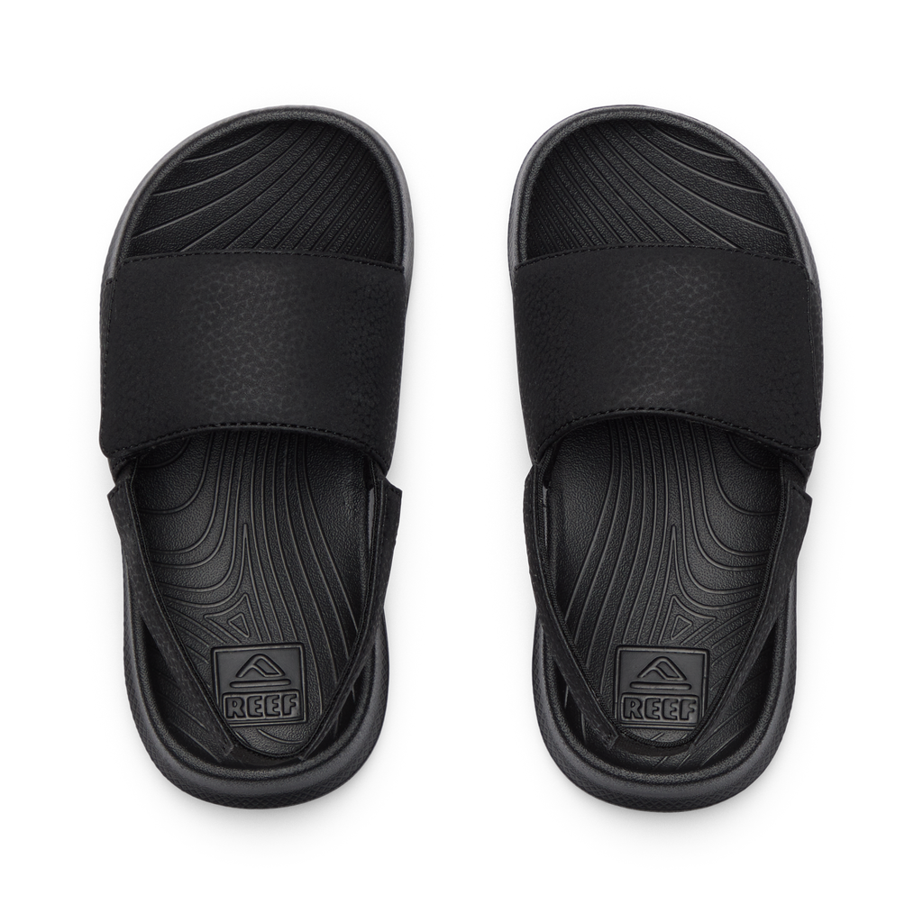 Top view of Little Salty Slide sandals for boys, featuring molded footbeds and soft cushioning for beach comfort.