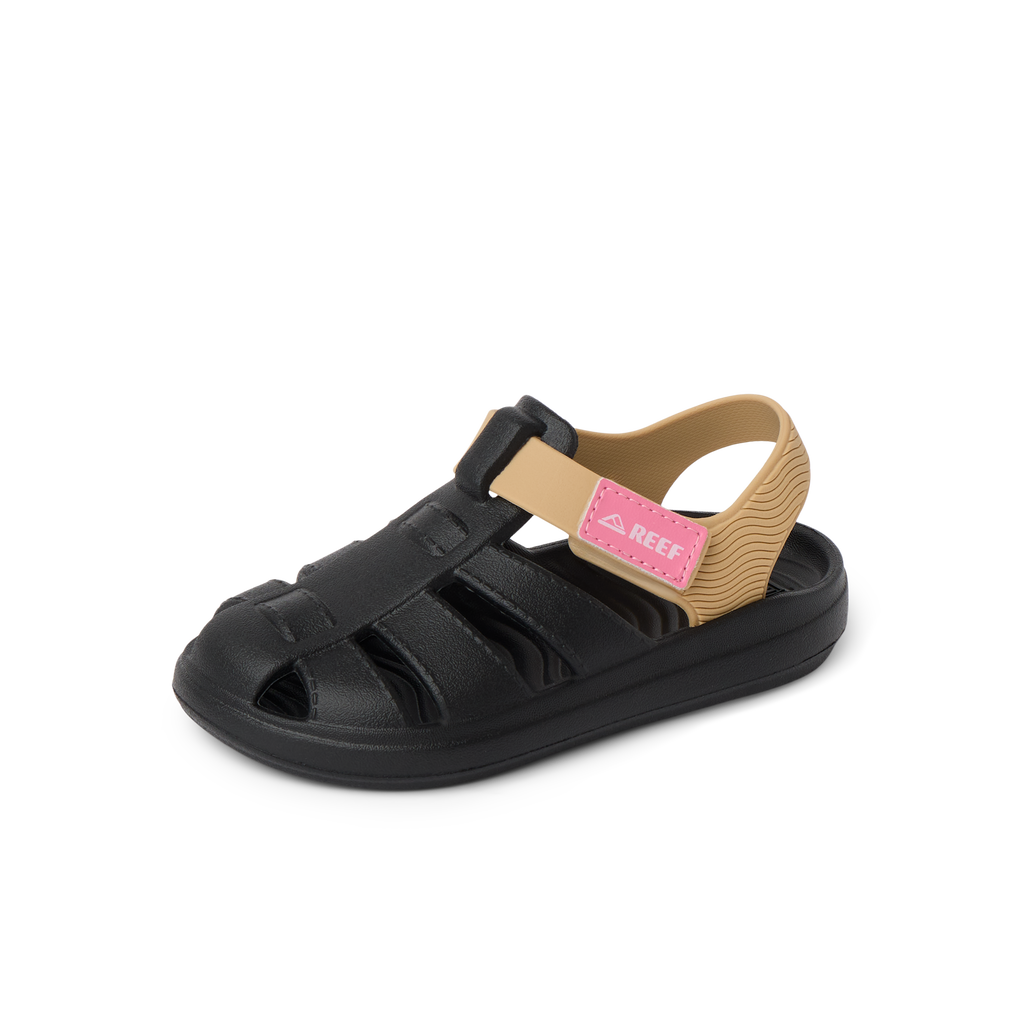 Little Totally Beachin left-facing kids sandal in black and tan with pink strap, showing front and side for beach comfort.