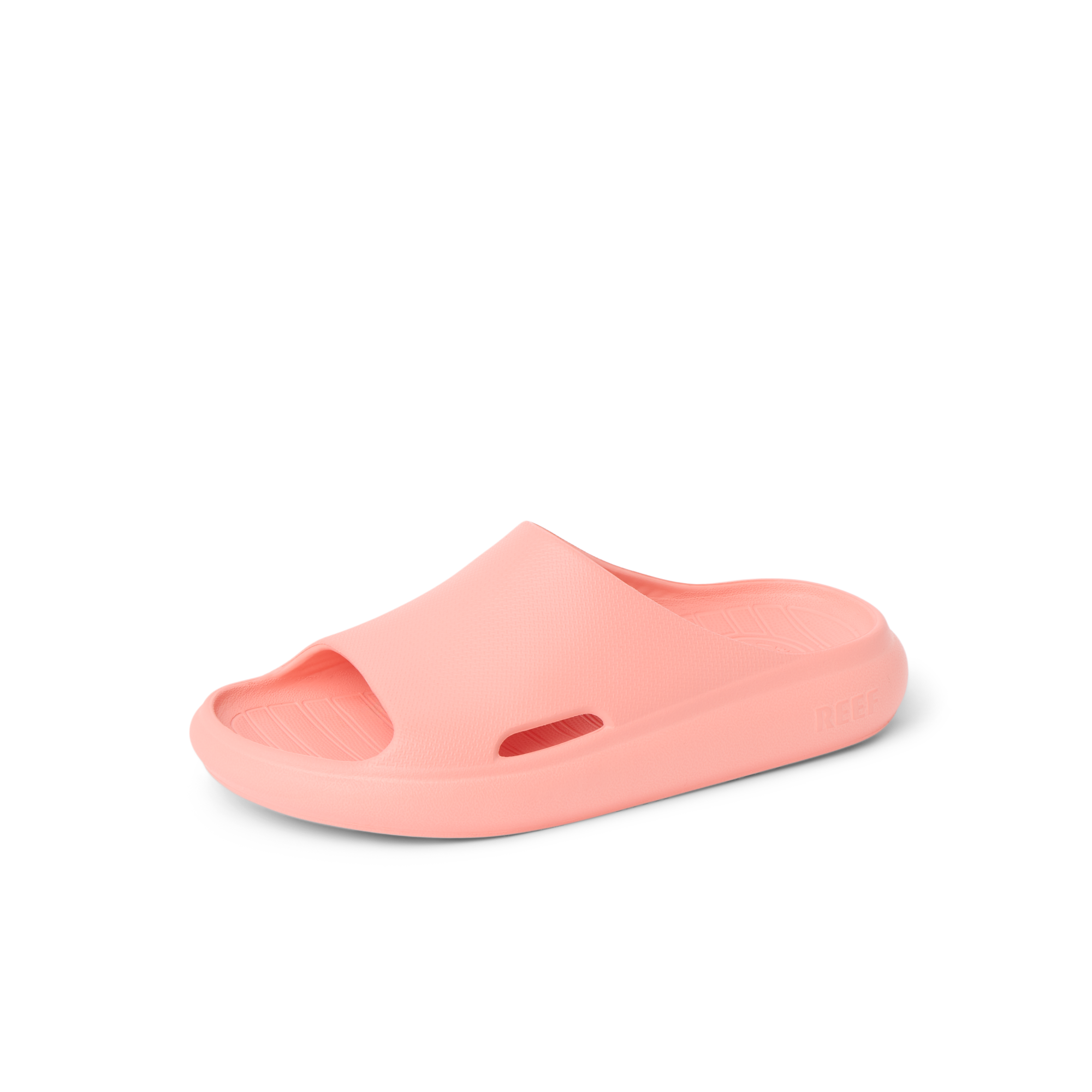 Kids Rio Slide coral unisex sandal facing right, close-up of lightweight, water-friendly molded footbed and arch support.