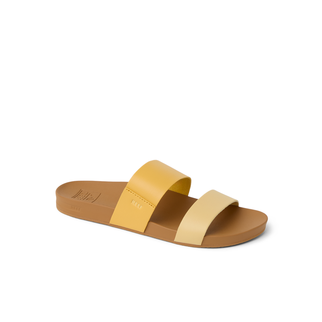 Cushion Vista women's slide sandal facing right with golden apricot dual straps, soft cushioning, and arch support for beach comfort.
