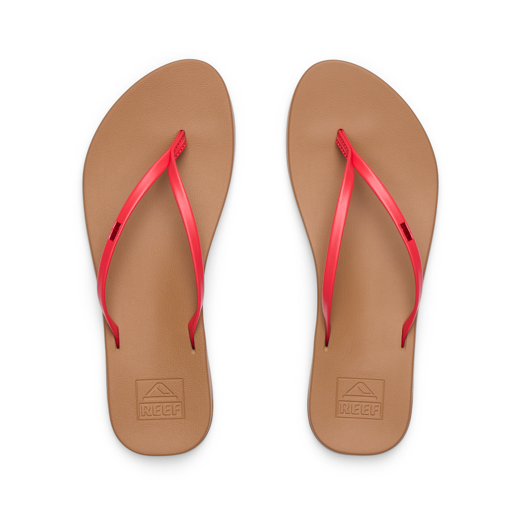 Pair of Cushion Slim women's flip-flops facing up showing tan footbed with red straps, water-friendly and comfort-focused design.