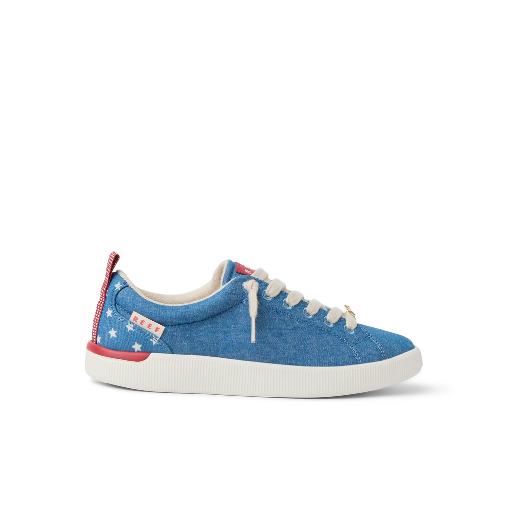 Neptune Alana sneaker facing left shows blue fabric with white stars, red heel tab, and comfortable lightweight design.