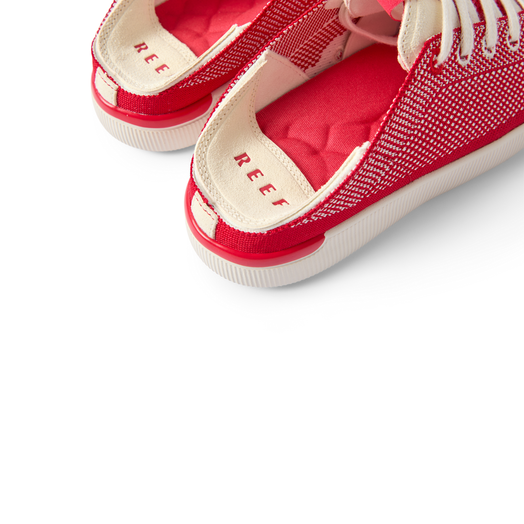 Close-up of the heel area of Reef Neptune women's footwear facing left, featuring cushioned arch support and breathable red fabric.