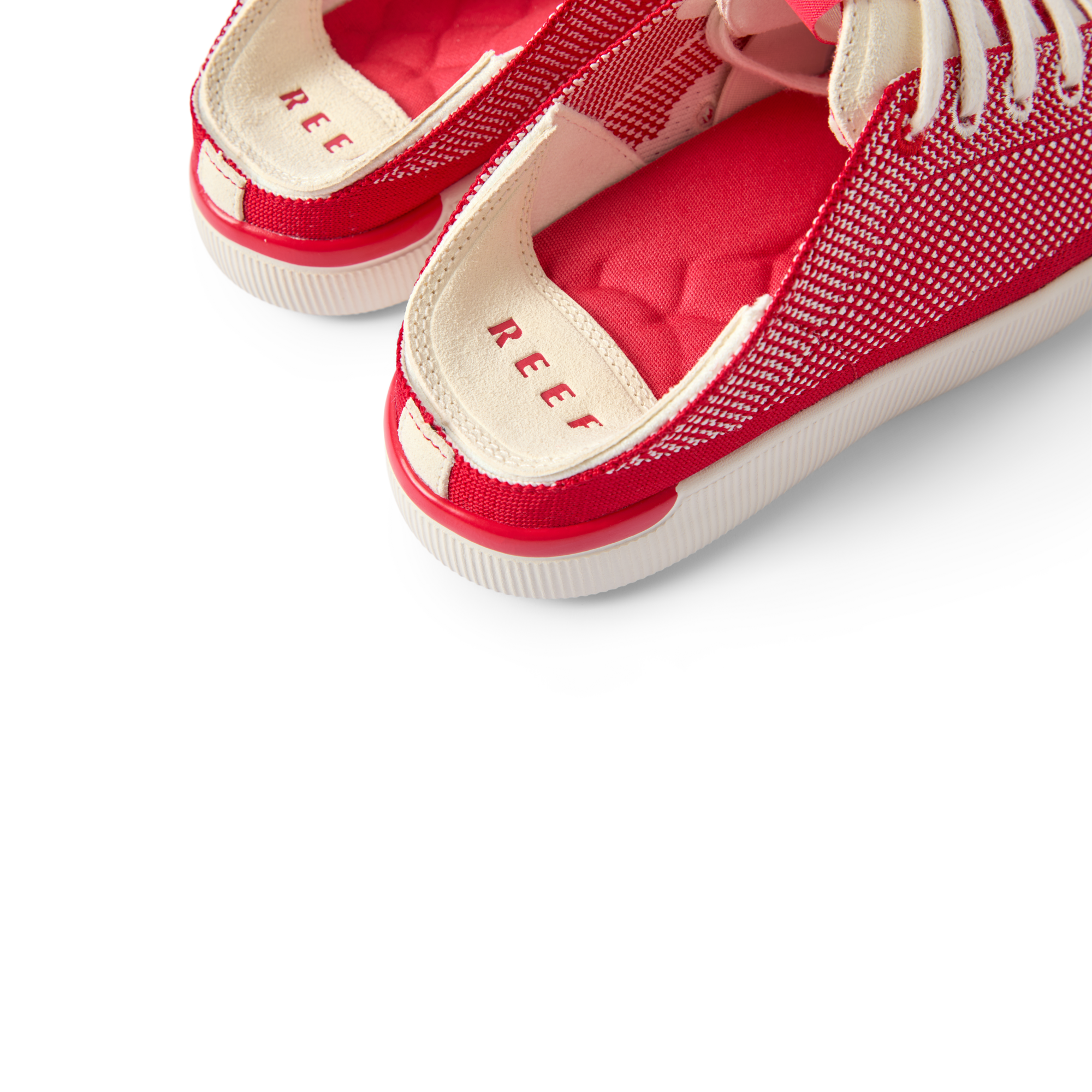 Close-up of the heel area of Reef Neptune women's footwear facing left, featuring cushioned arch support and breathable red fabric.