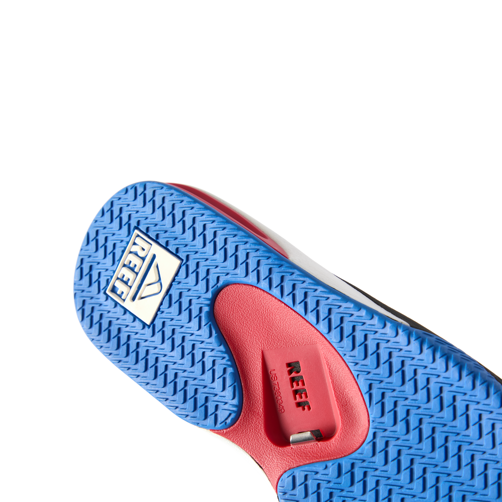 Fanning men's footwear close-up of outsole facing up showing textured blue rubber sole with anatomical arch support in red.
