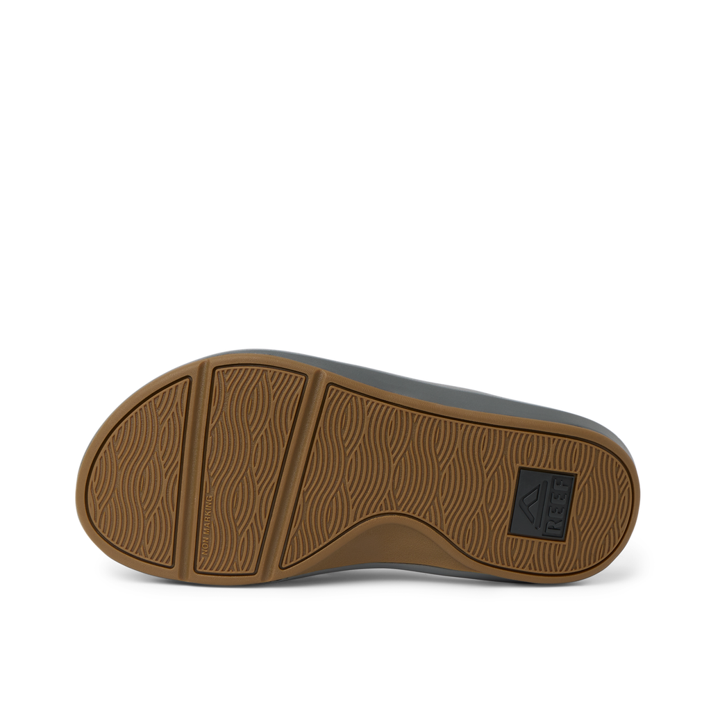 Cruiser men's shoe showing the brown rubber outsole facing up with wave-pattern tread, designed for comfort and durability.
