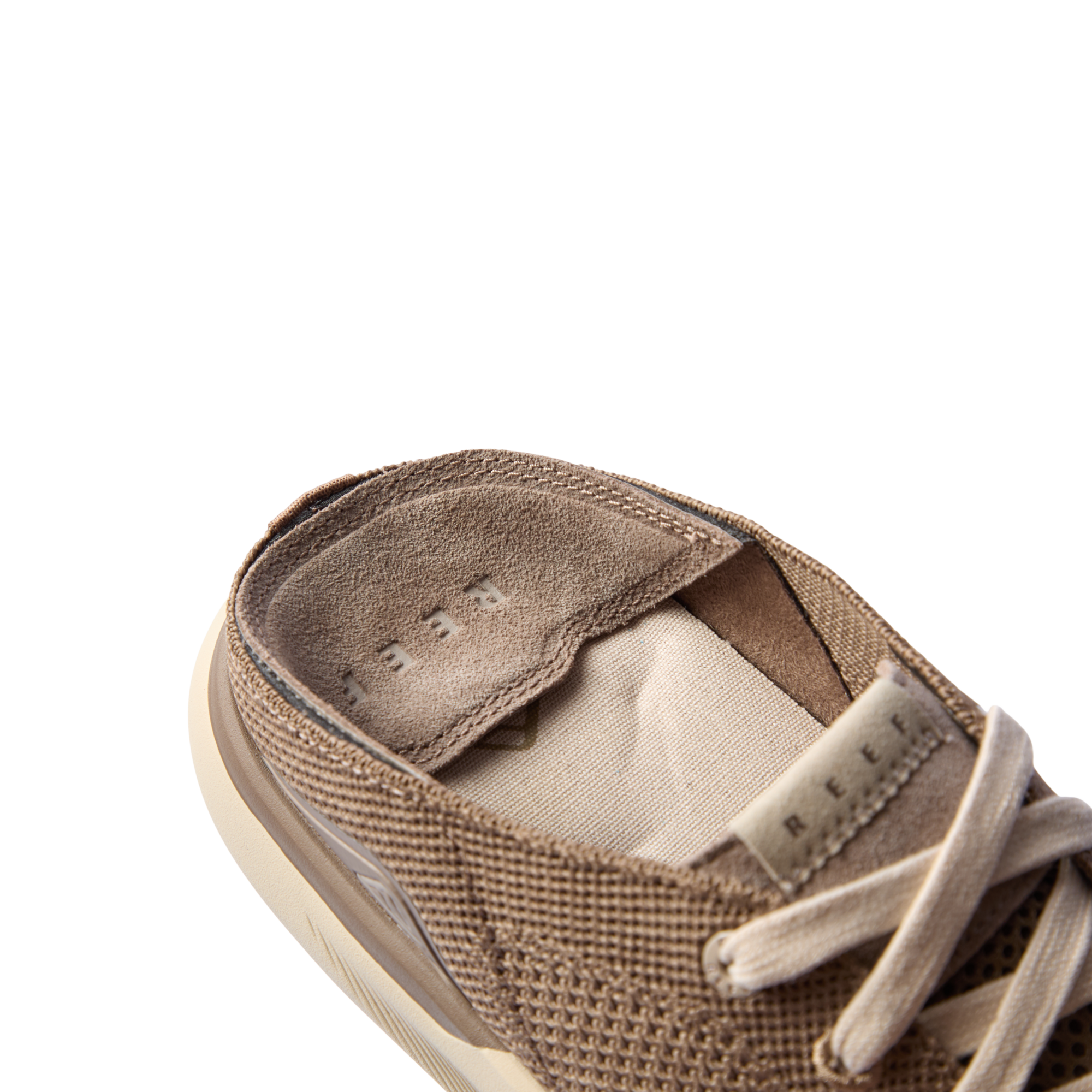 Close-up of the Neptune HT tan sneaker collar and padded tongue showing breathable knit upper and REEF label.