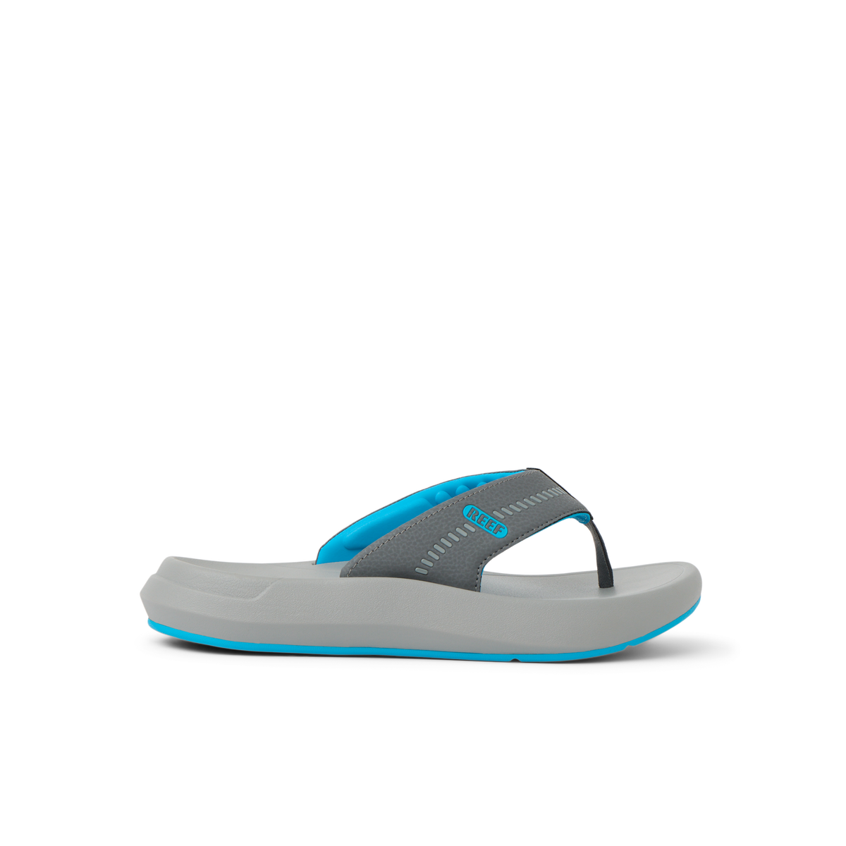 Cruiser flip flop facing right with charcoal gray straps, aqua accents, and cushioned sole for beach comfort by REEF.