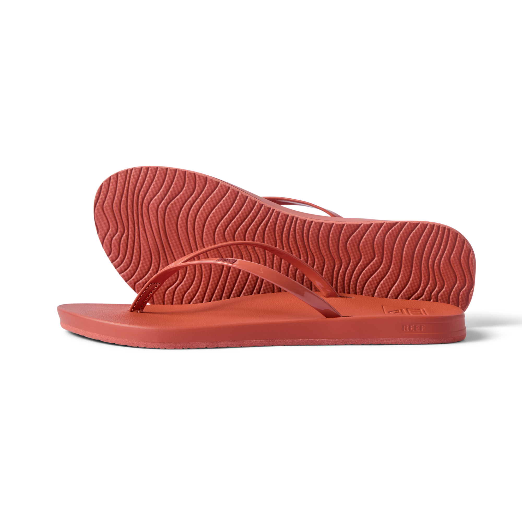 Side view of women's Cushion Slim flip flops in coral, showing sole and slim straps with arch support, water-friendly and comfortable.