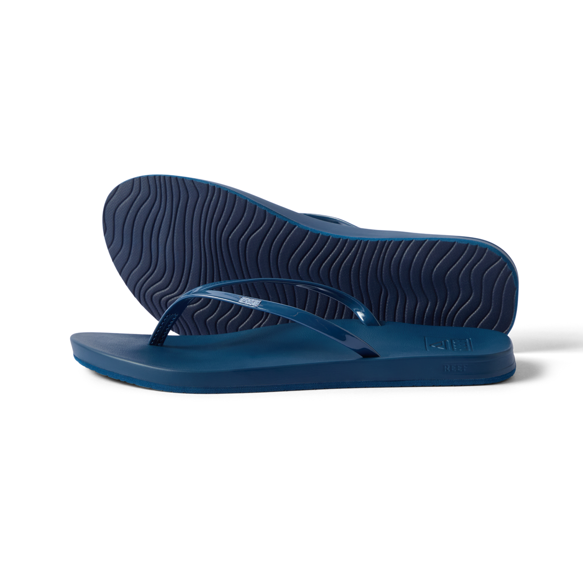 Cushion Slim navy flip flops facing left with top and sole view, water-friendly with anatomical arch support and cushioning.
