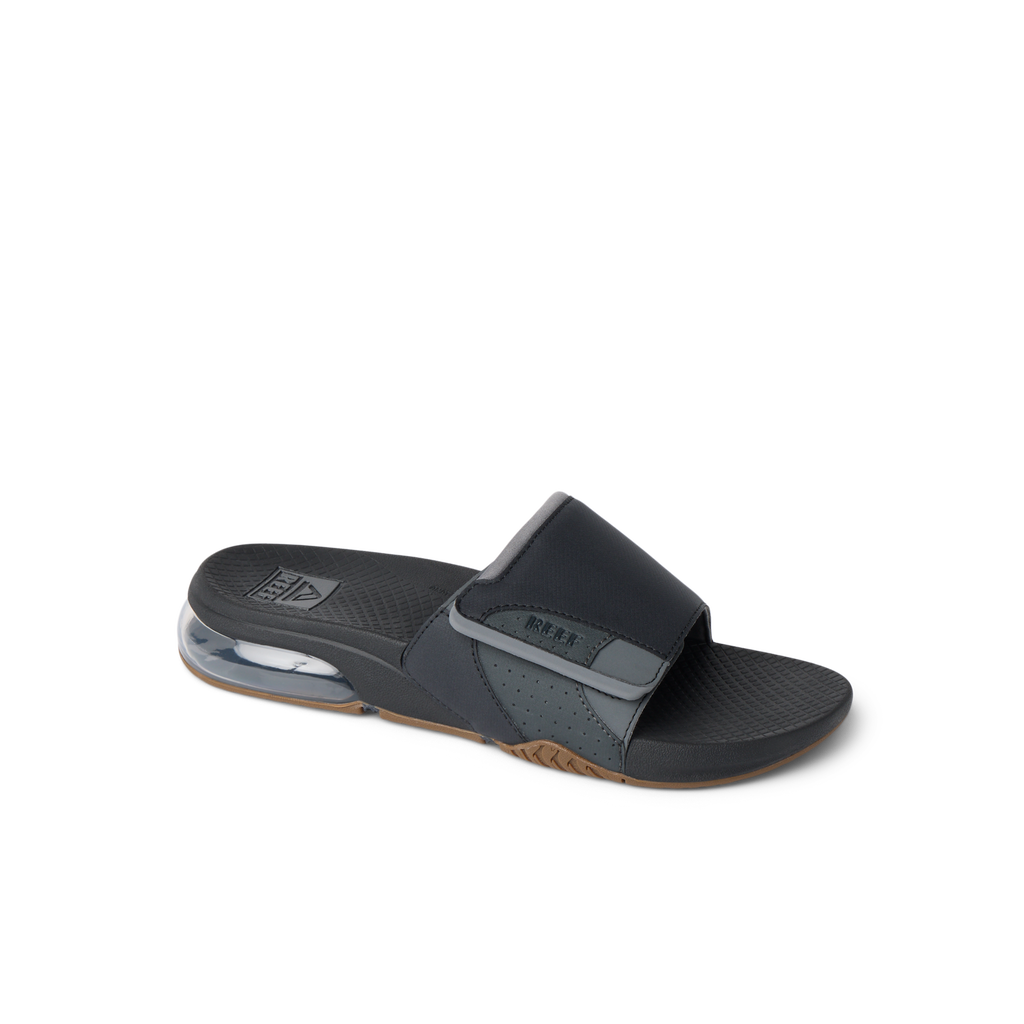 Fanning + Slide facing right, black and grey water-friendly men's sandal with REEFlex EVA cushioning and oversized airbag heel.