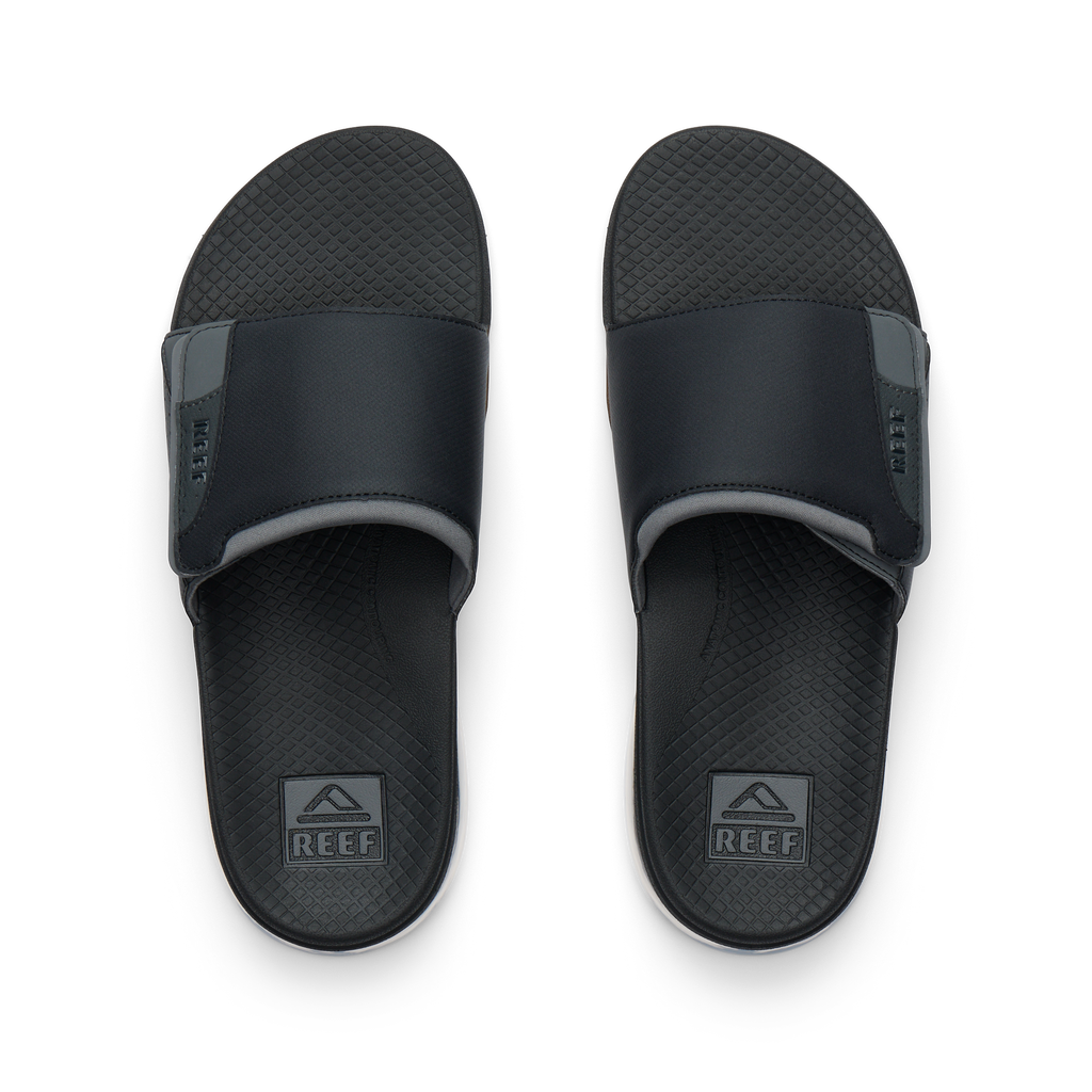 Pair of Fanning + Slide men's black water-friendly slides overhead, soft cushioned footbeds with anatomical arch support.