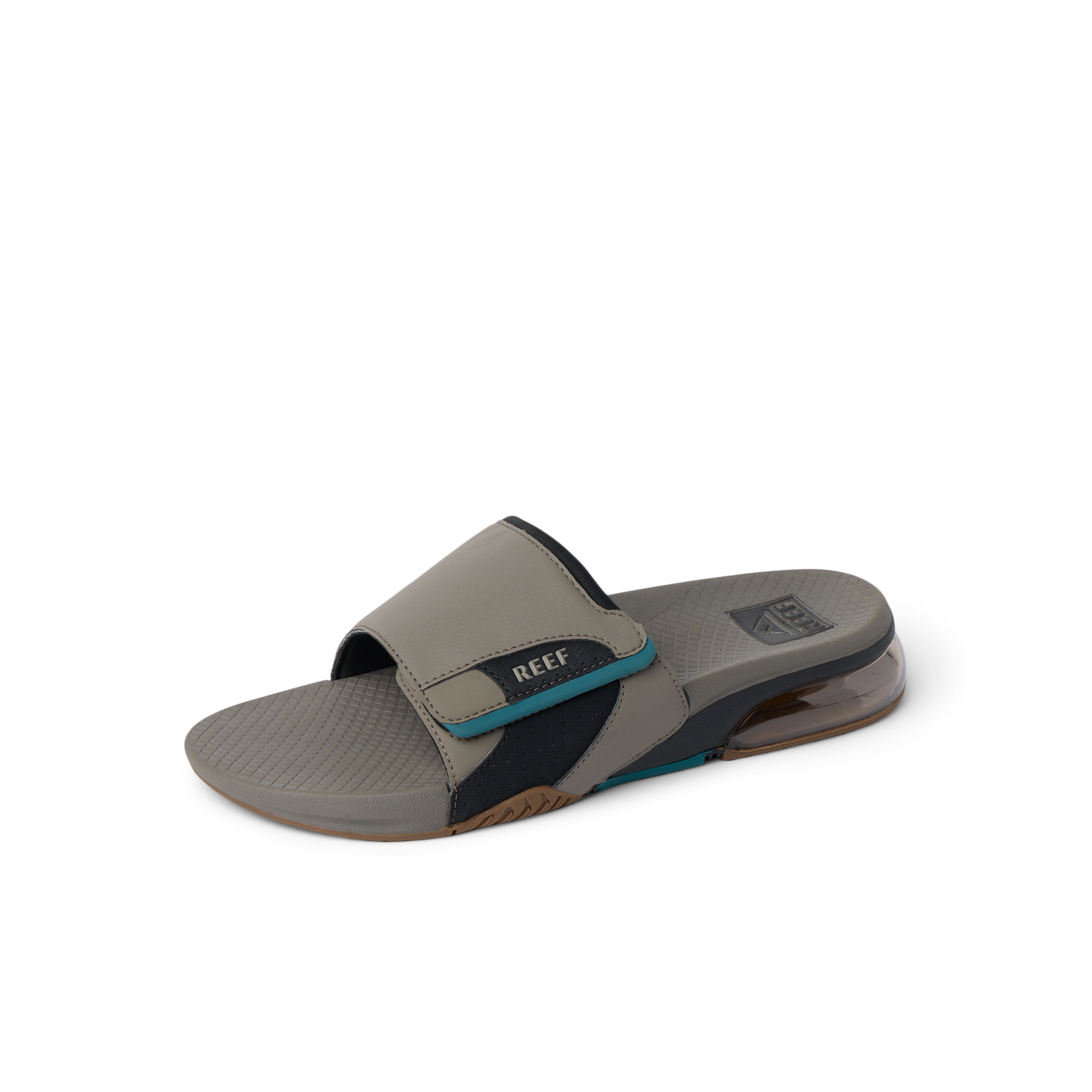 Fanning + Slide facing left, men's tan and spruce water-friendly slide with oversized airbag heel and cushioned footbed