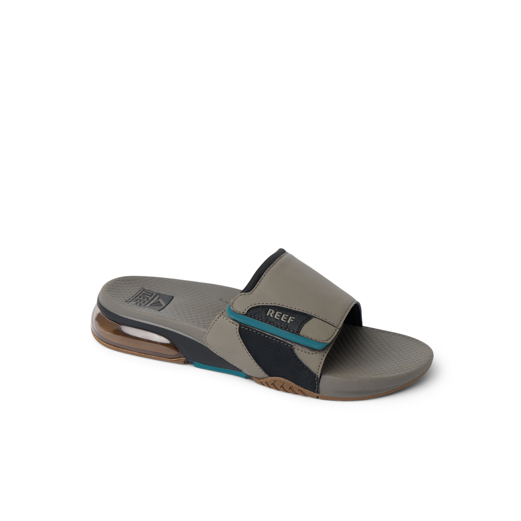 Fanning + Slide facing left, men's tan and spruce water-friendly sandal with oversized airbag heel and REEFlex cushioning