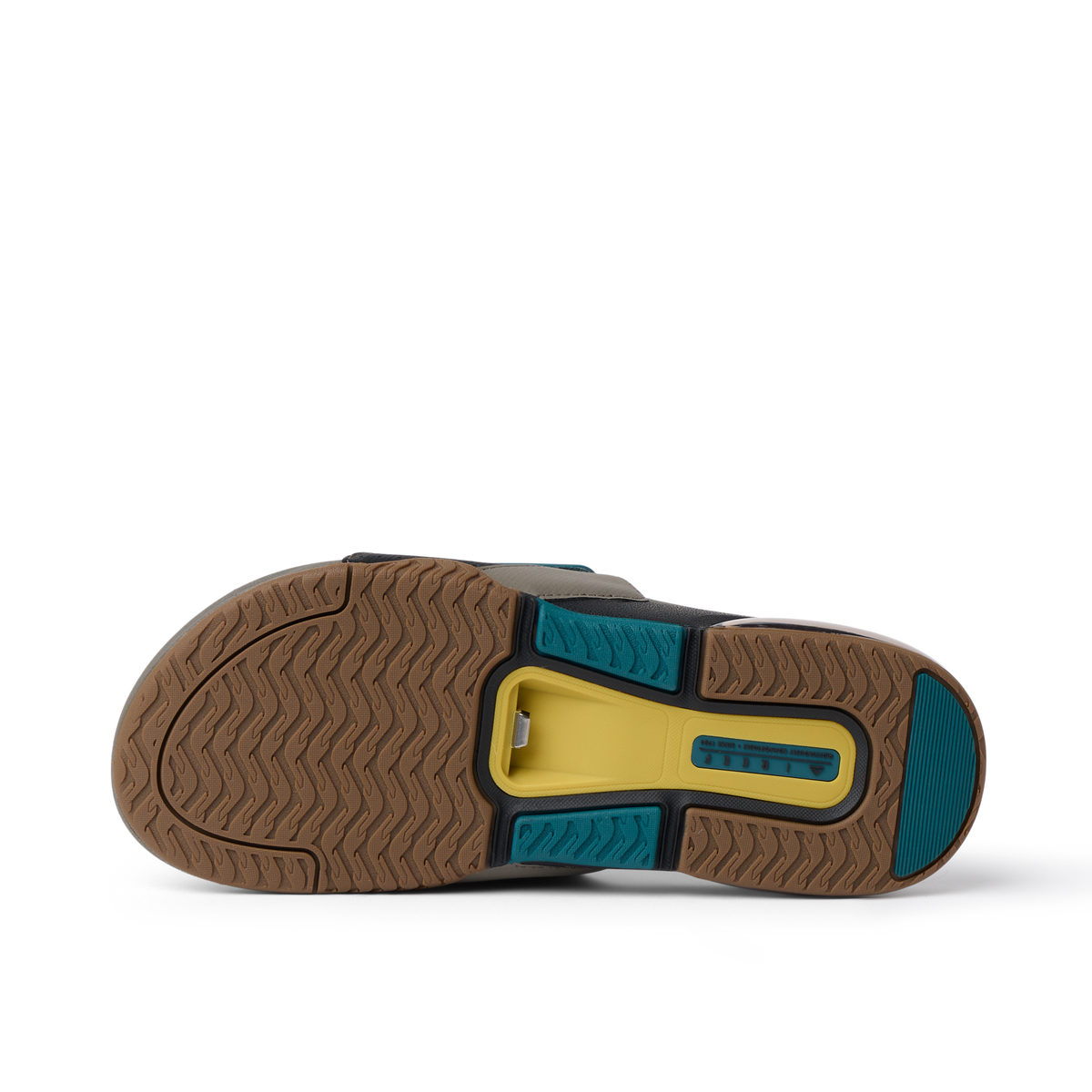 Fanning + Slide sole facing up, showing tan, spruce, and yellow textured tread with oversized airbag heel cushioning for comfort