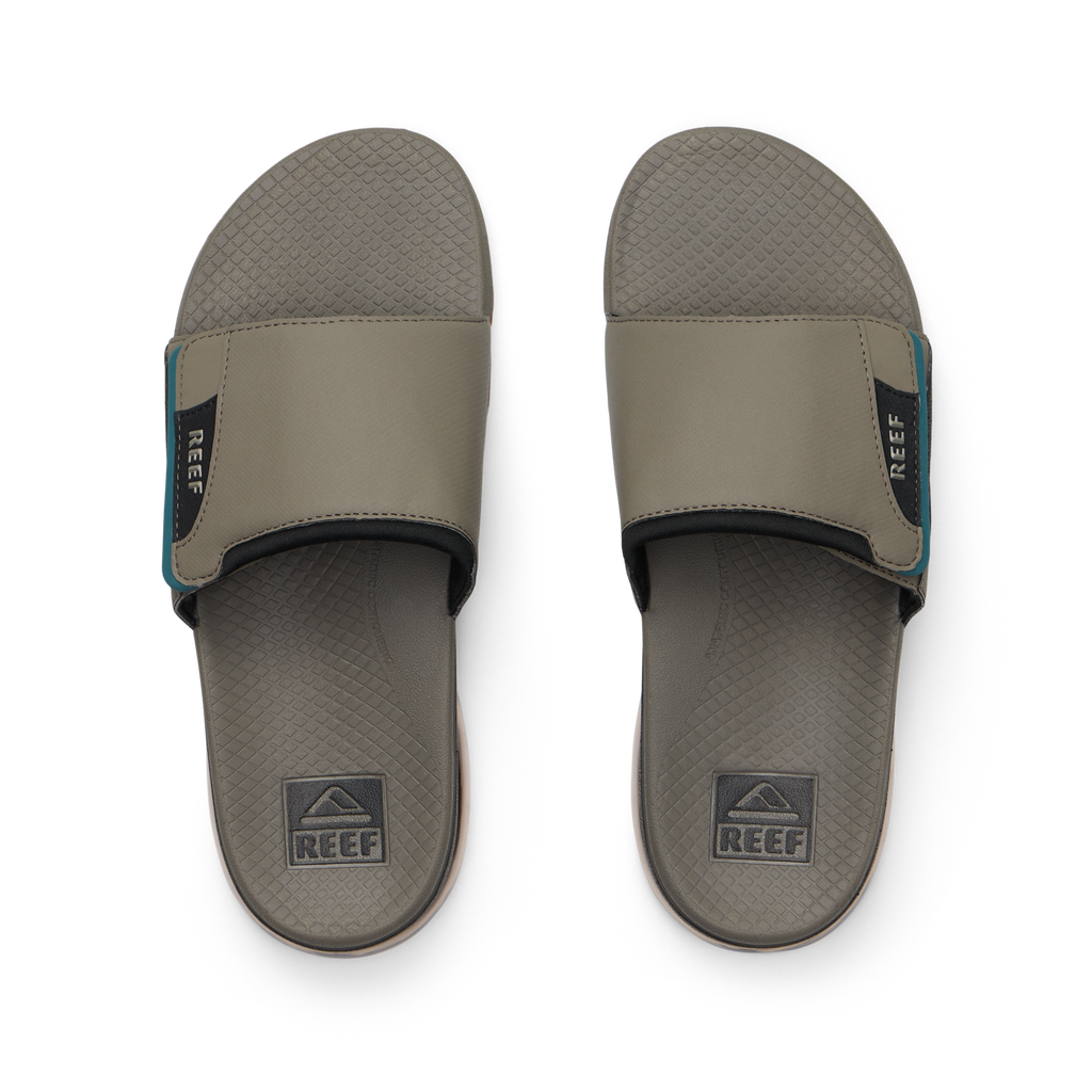 Pair of Fanning + Slide men's brown and spruce water-friendly slides overhead with cushioned footbeds and anatomical arch support.