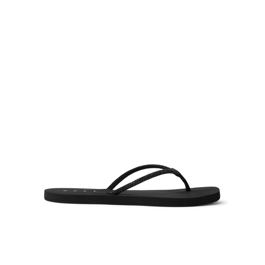 Bliss Bling Fling women's black water-friendly flip flop facing left, showing side profile with cushioned sole and arch support.