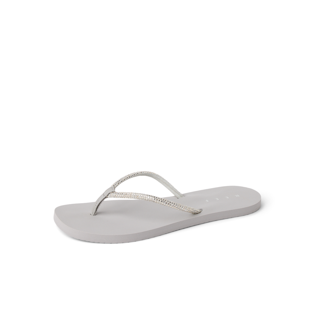 Bliss Bling Fling silver women’s flip flop facing left, soft-rebound cushioning with anatomical arch support for beach comfort