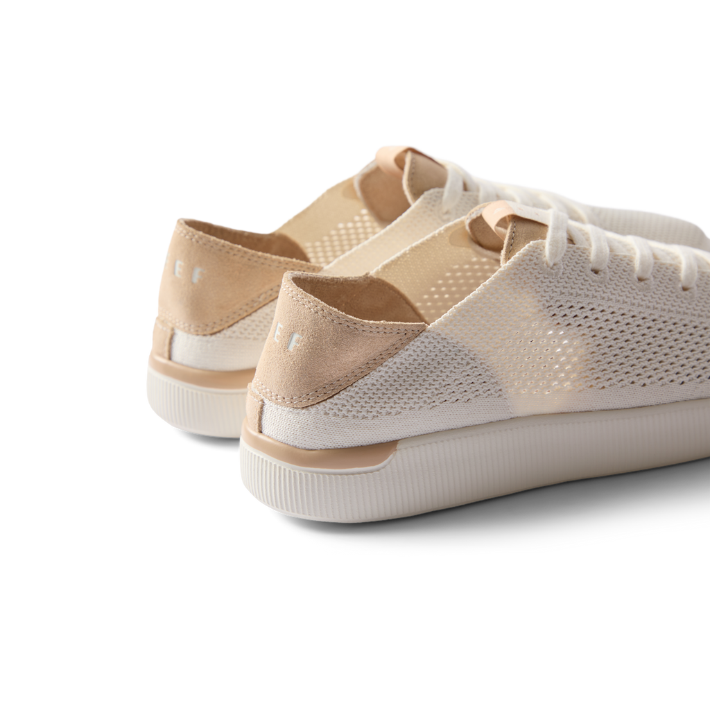 Reef Neptune women's white champagne sneakers facing back right, showing heel and side with surf-inspired comfort features.
