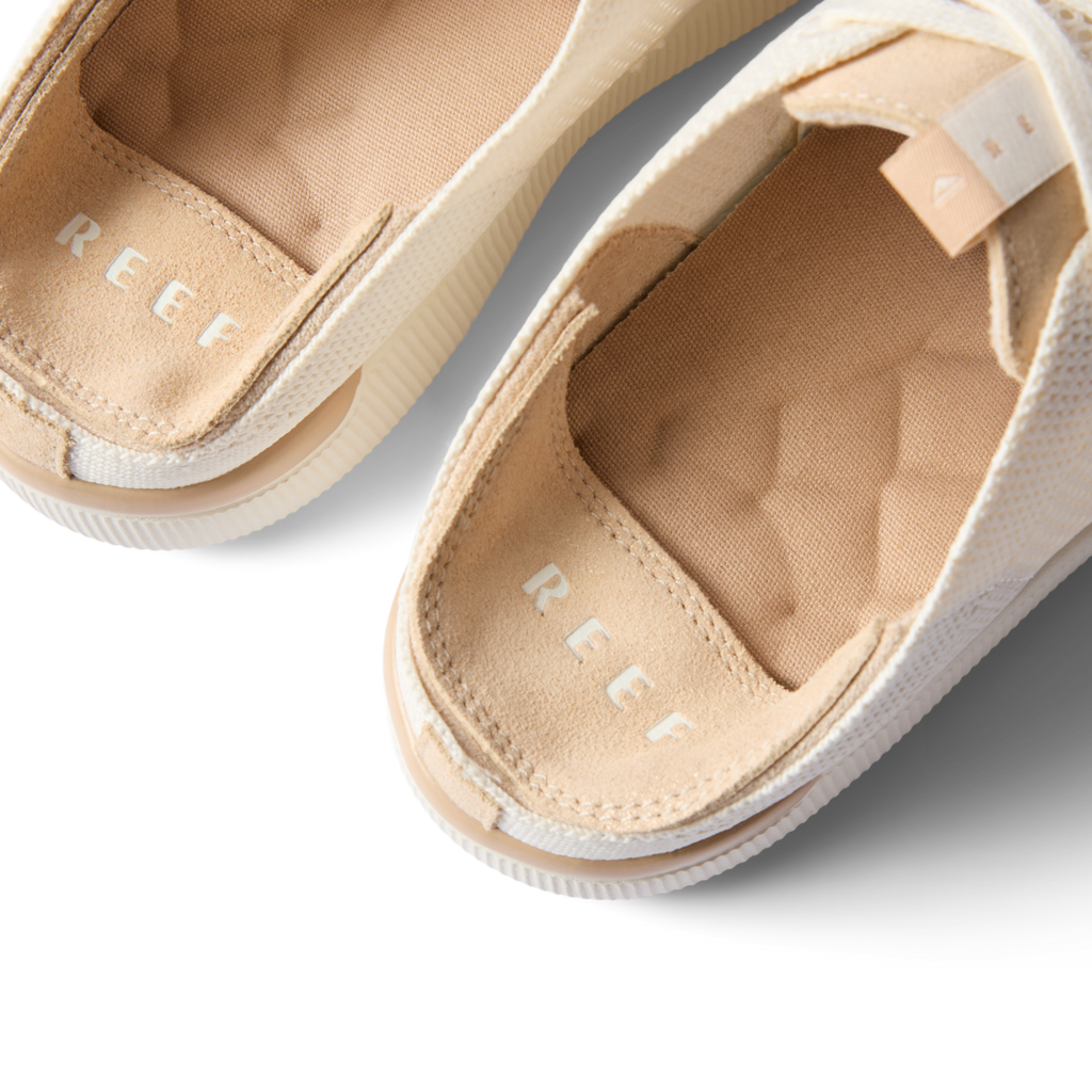 Close-up of the footbed and heel of Reef Neptune sandals in white champagne, highlighting comfort and arch support.