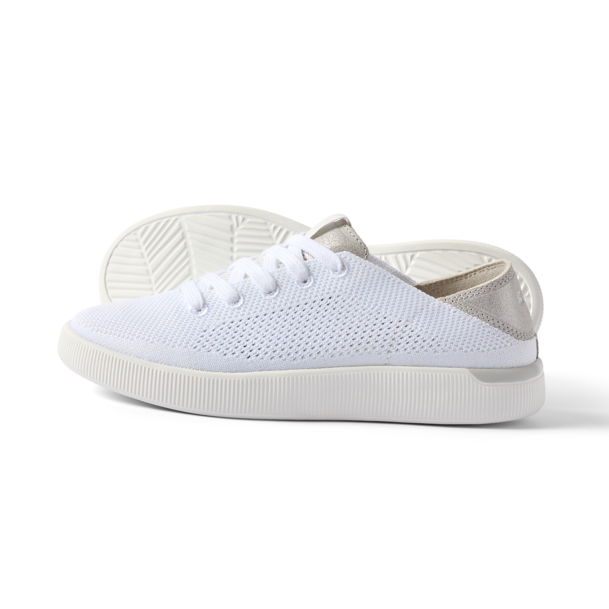 Reef Neptune women’s white and silver sneaker facing right, lightweight knit upper with cushioned sole for beach comfort.