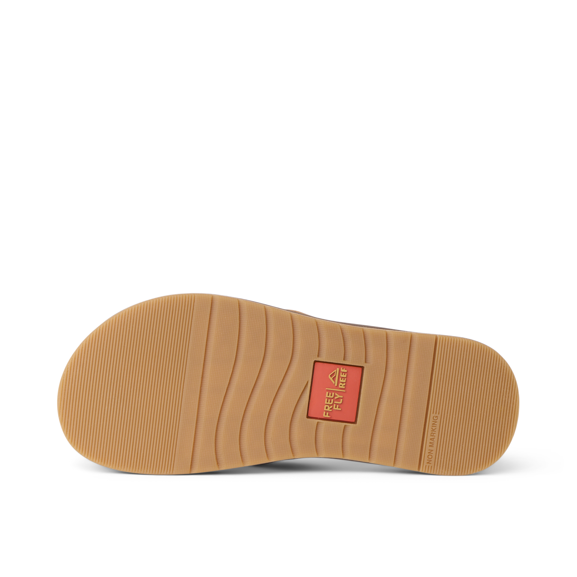 Free Fly X Ojai sandal outsole facing up, showing durable rubber tread with flex grooves and branded logo patch center