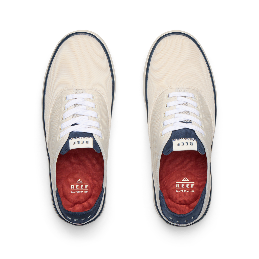 Top-down view of Neptune Lido men's shoes in tan and navy with Reef branding, featuring soft cushioning and arch support.