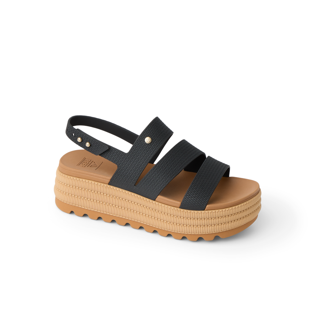 Water Vista Higher 2 sandal facing right, black straps with tan platform sole, offering beach comfort and support.