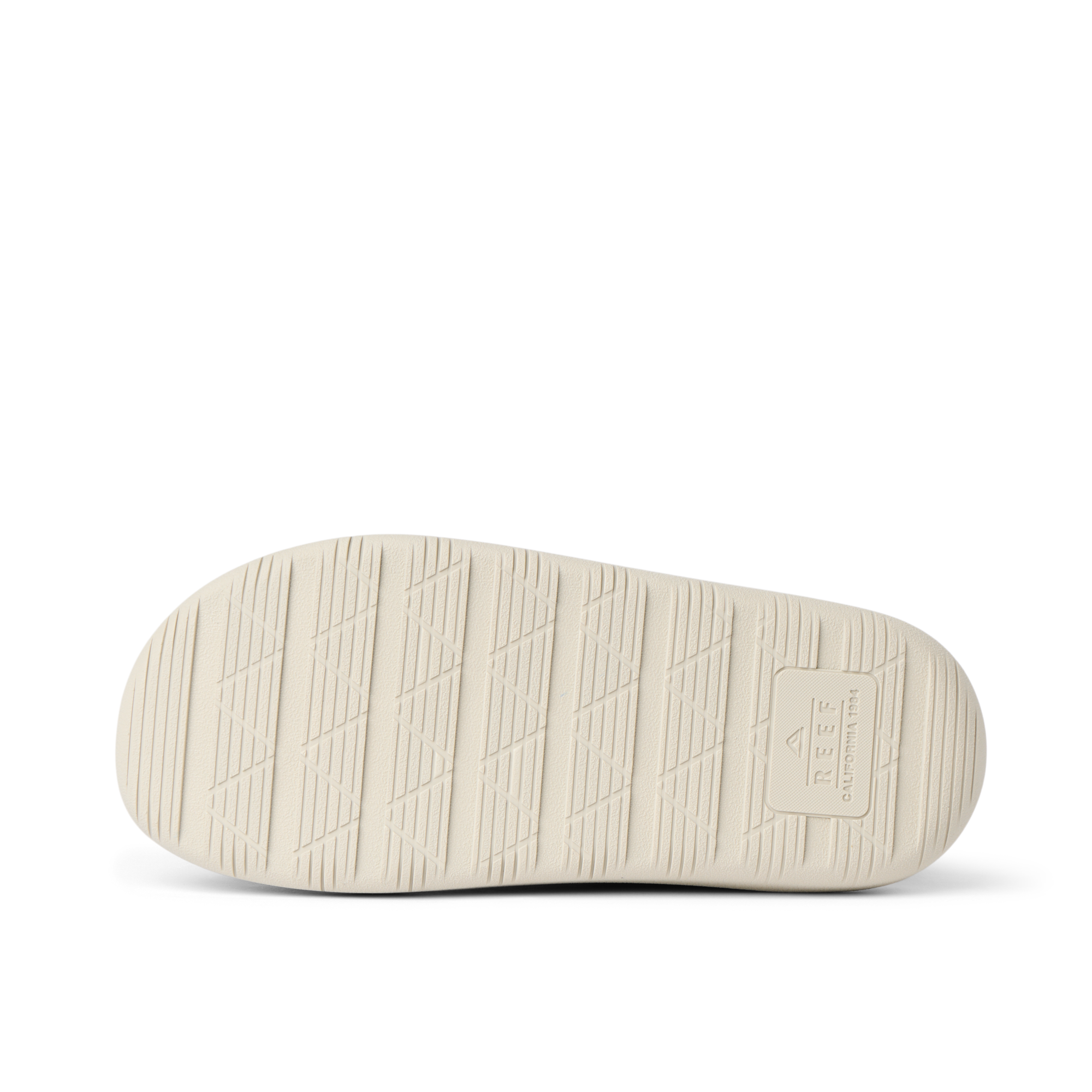 Rambler Kicker sandal sole facing up in off-white with textured grip and REEF branding for durable, lightweight comfort