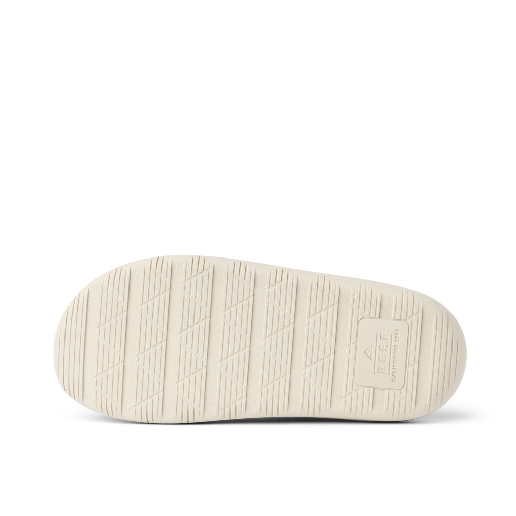 Rambler Kicker sandal sole facing up in off-white with textured grip and REEF logo for lightweight, durable comfort and traction