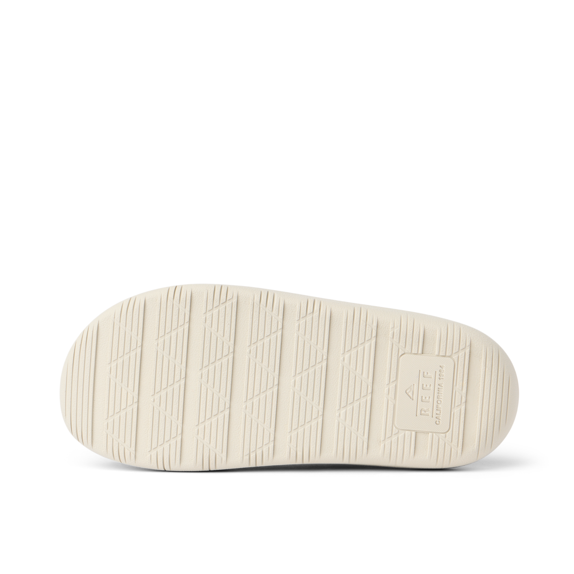 Rambler Kicker sandal sole facing up in off-white with textured grip and REEF logo for lightweight, durable comfort and traction