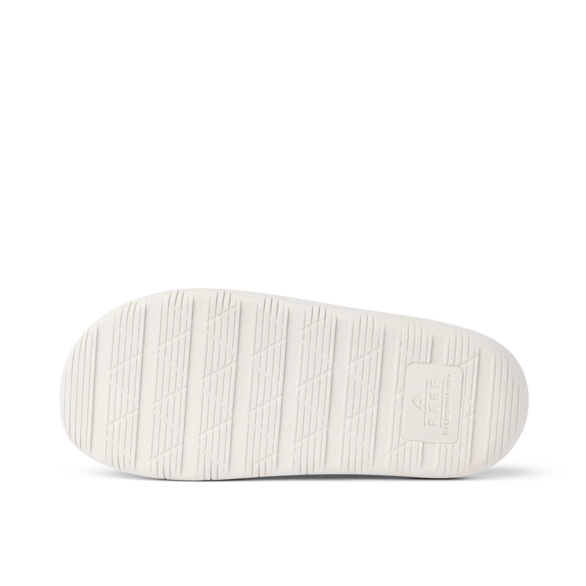 Rambler Kicker sandal sole facing up in off-white with textured grip and REEF logo for durable, lightweight beach comfort