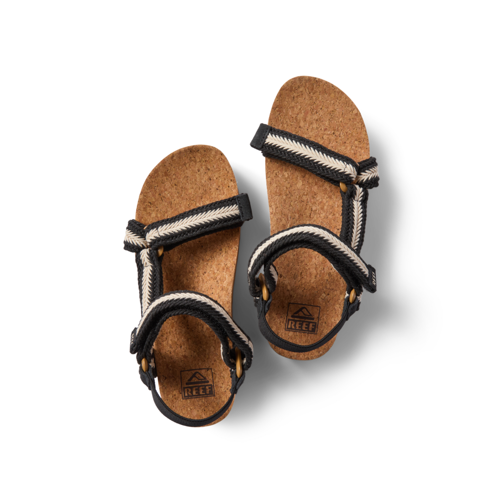 Top view of women's Cushion Rem Hi sandals with black and white braided straps and cork footbeds facing forward.
