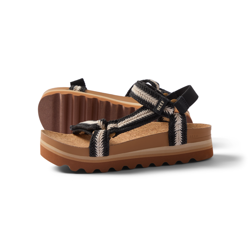 Pair of Cushion Rem Hi sandals for women facing right, braided straps, soft cushioning, and textured soles for beach comfort.