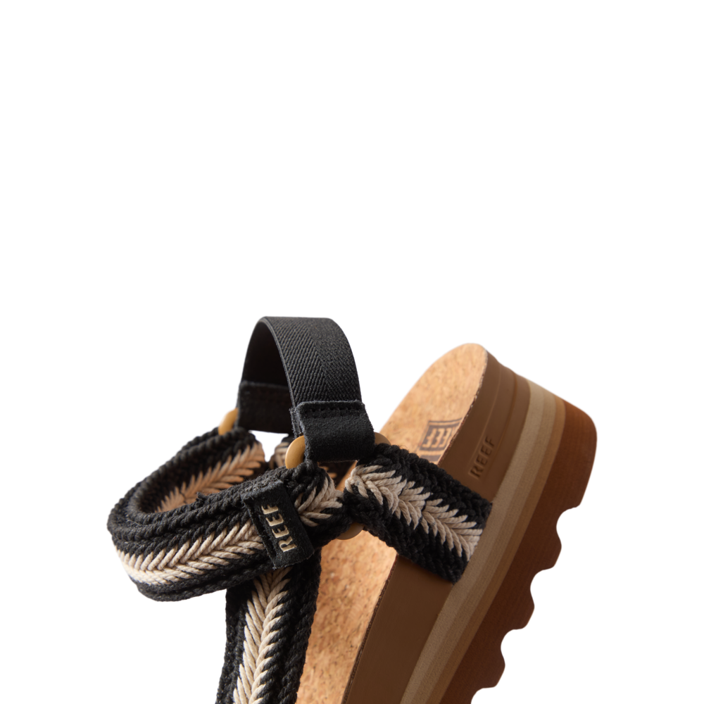 Cushion Rem Hi sandal facing left, close-up on upper with braided black and white straps and cushioned cork footbed