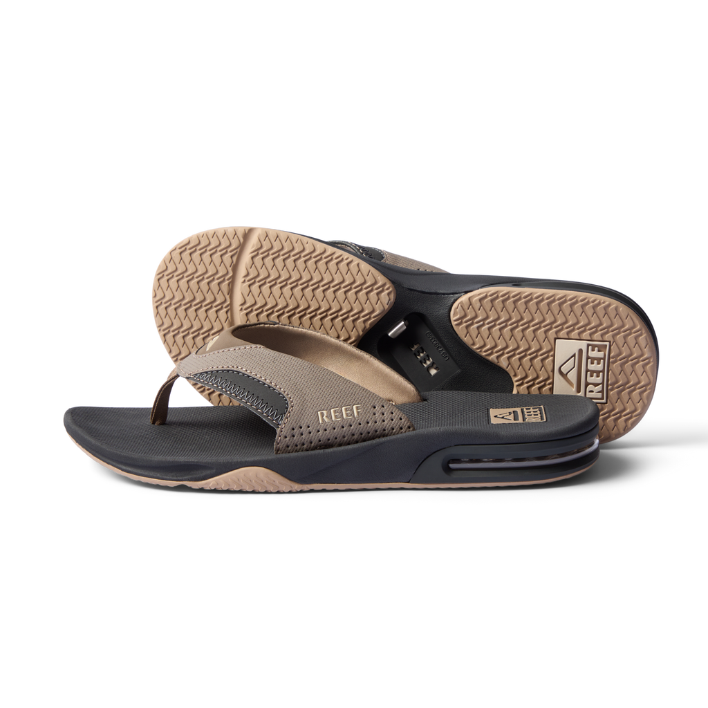 Pair of Fanning flip flops, one facing left side and one sole up, showing cushioned arch support and water-friendly materials.