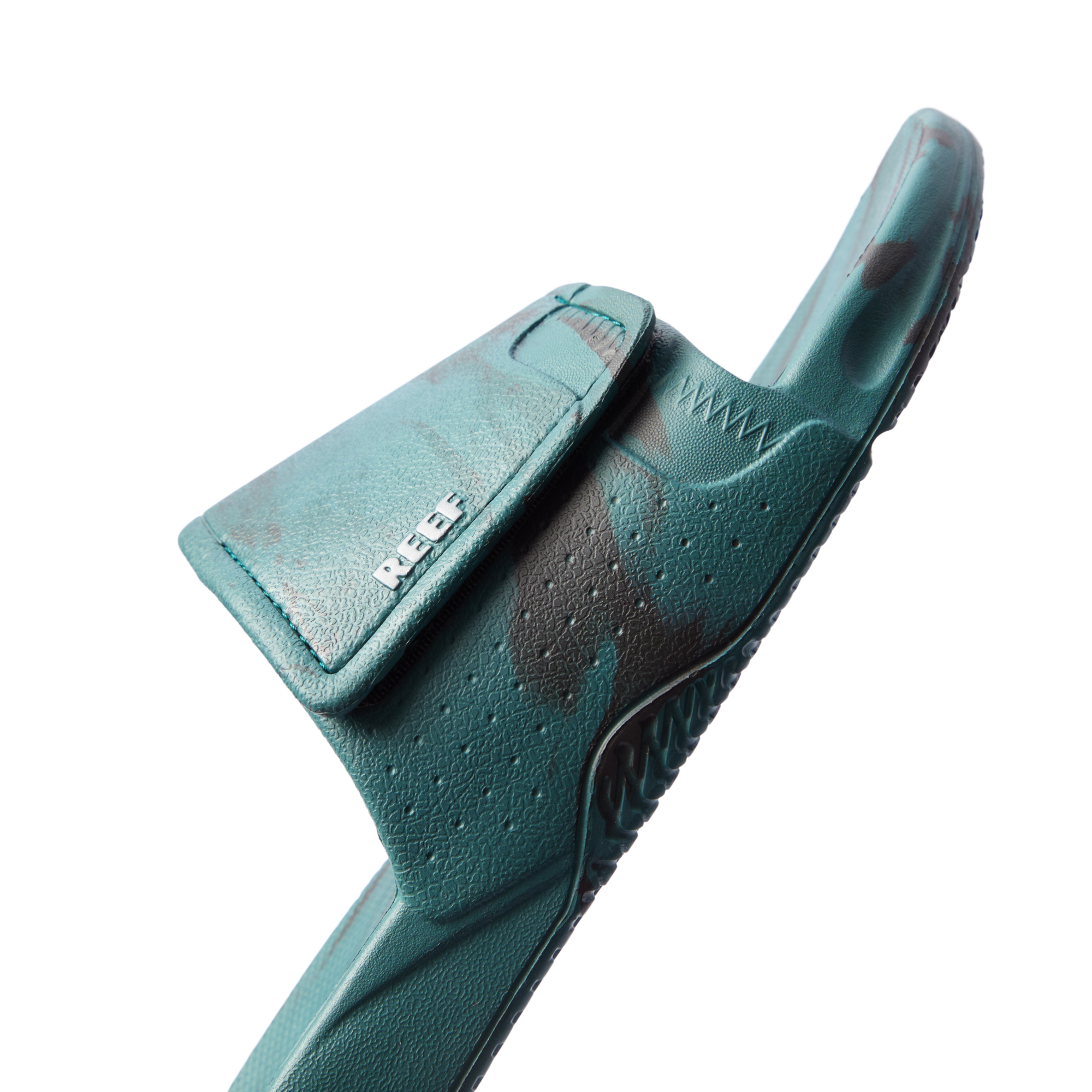 Fanning Slide H2O in deep teal marble facing right, close-up on front strap with breathable perforations and arch support.