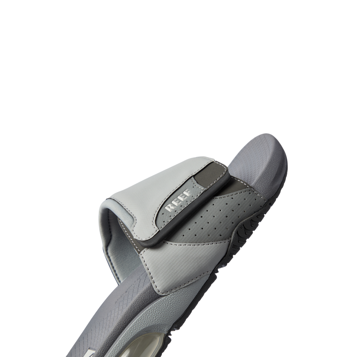 Fanning + Slide sandal facing right in grey with breathable adjustable strap, cushioned footbed, and water-friendly design