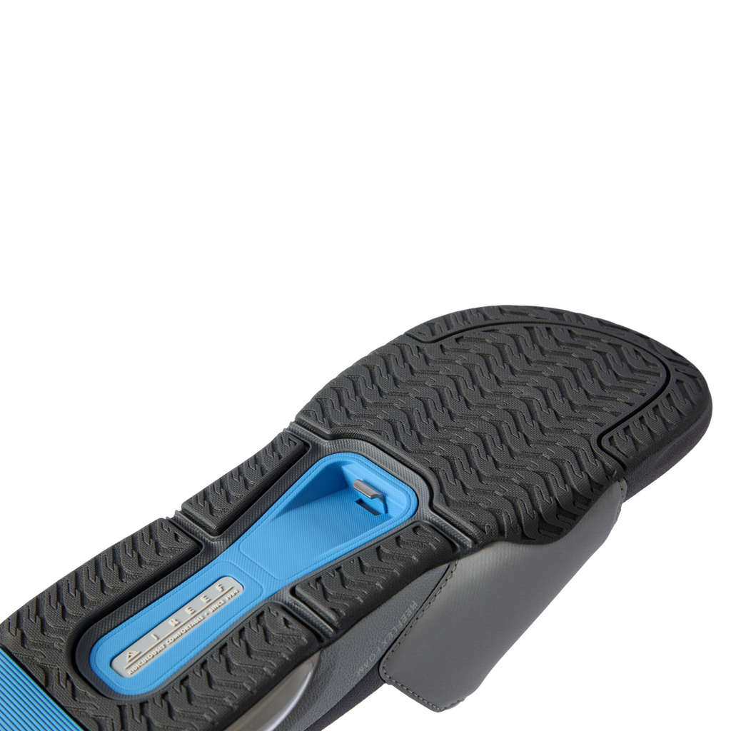 Fanning + Slide sandal sole facing up with textured black and blue water-friendly tread for durable traction and comfort support